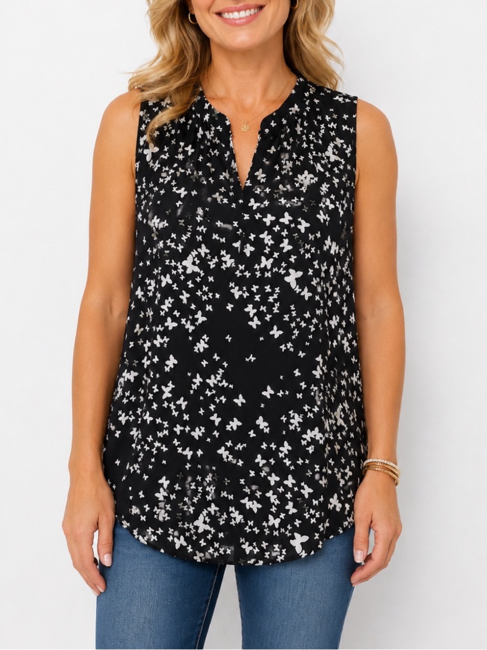 Alice Blue black sleeveless blouse featuring an all-over white butterfly/floral